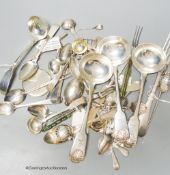 A mixed collection of silver and white metal spoons and other flatware including three 19th century