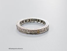 A mid 20th century white metal (stamped 18ct) and diamond set full etenity ring, size M, gross