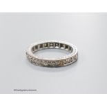 A mid 20th century white metal (stamped 18ct) and diamond set full etenity ring, size M, gross