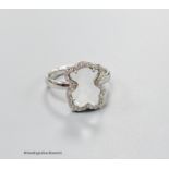 A modern Tous 750 white metal and facetted rock crystal dress ring, with diamond chip set border,