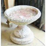 A circular reconstituted stone garden bird bath, diameter 38cm, height 34cm