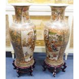 A pair of large Japanese vases, on hardwood stands