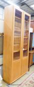 An Ercol Windsor elm two door display cabinet, width 91cm, depth 32cm, height 206cm