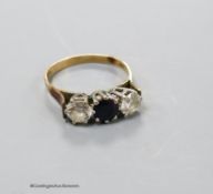 A 9ct gold, sapphire and simulated diamond set three stone ring, size P, gross 2.6 grams.