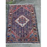 A Caucasian brick red ground rug, 150 x 108cm