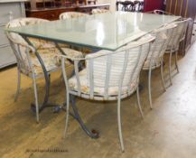 A rectangular glass topped wrought iron garden table and eight chairs. Table, 200x100x75cm.