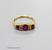 An early 20th century 18ct, three stone ruby and four stone diamond chip set half hoop ring, size