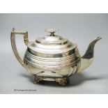 A George IV silver shaped oval teapot, by Naphthali Hart, London, 1824, with reeded and floral