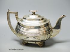 A George IV silver shaped oval teapot, by Naphthali Hart, London, 1824, with reeded and floral