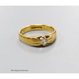 An 18ct gold and claw set solitaire diamond ring, size Q, gross 5.5 grams.