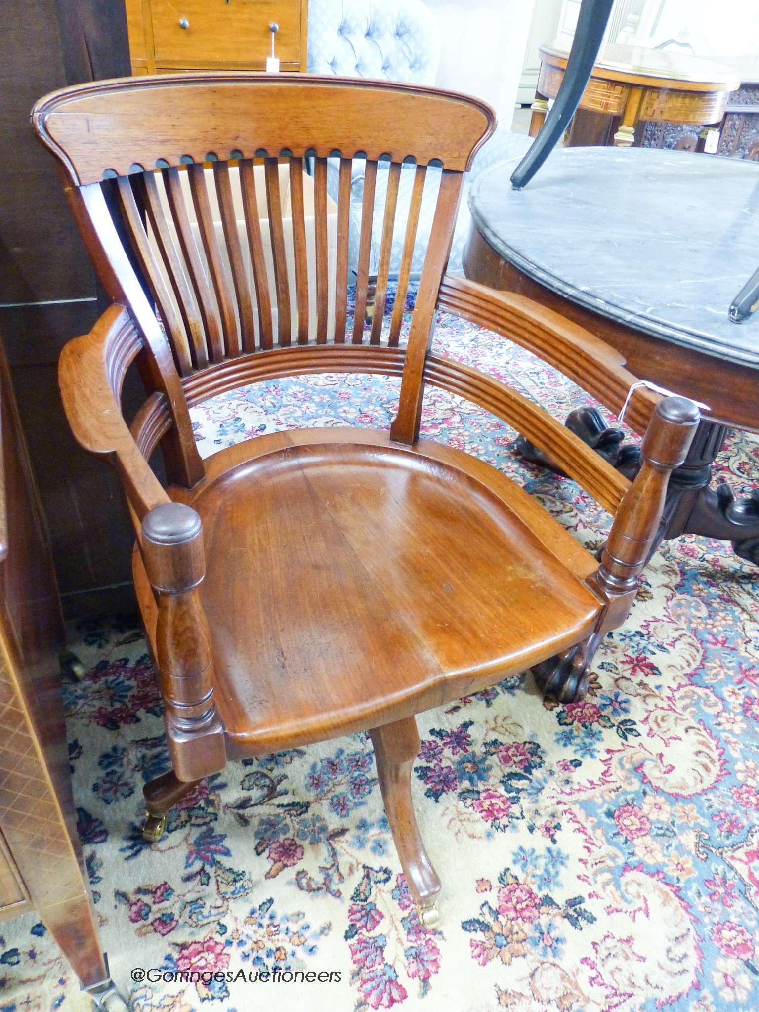 A late Victorian walnut revolving desk chair, width 58cm, depth 52cm, height 92cm