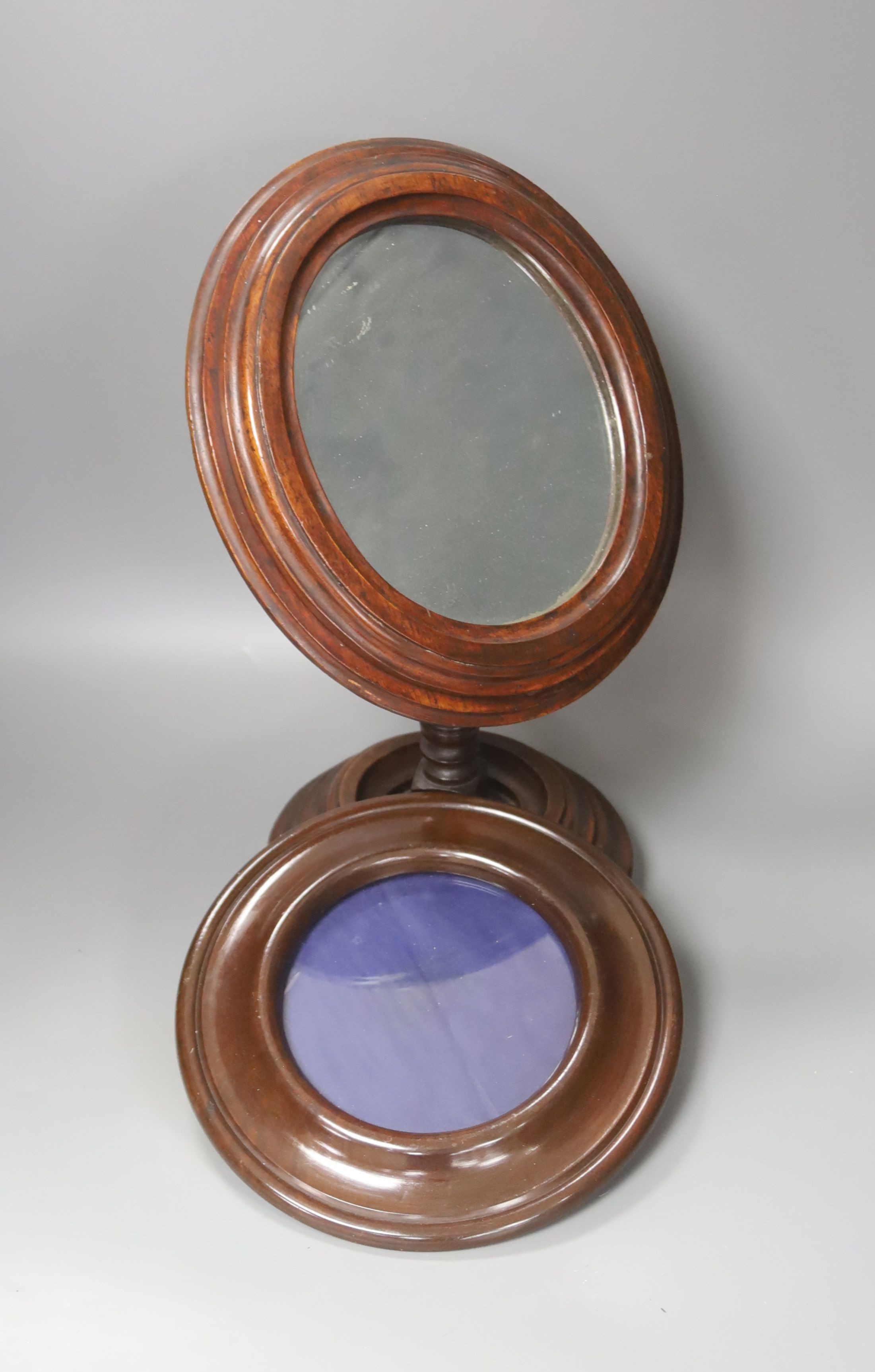 An oval mahogany-framed pedestal shaving mirror and circular mahogany picture frame