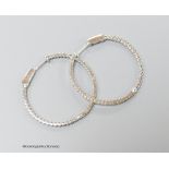 A modern pair of 18ct white gold and diamond chip set hoop earrings, diameter 32mm, gross weight 5.