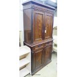 A late 19th century French rosewood two part cupboard with two drawers and panelled doors, width