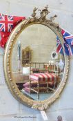 A Victorian oval giltwood and gesso wall mirror, width 61cm, height 86cm