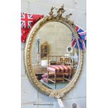 A Victorian oval giltwood and gesso wall mirror, width 61cm, height 86cm