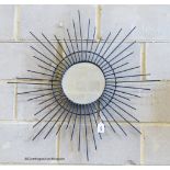 A metalwork star burst wall mirror, height 84cm