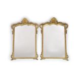 A pair of Georgian style carved giltwood wall mirrors,with shaped rectangular plates, scallop
