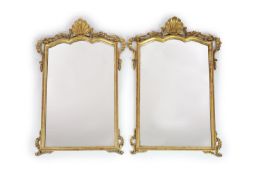 A pair of Georgian style carved giltwood wall mirrors,with shaped rectangular plates, scallop