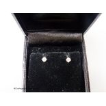 A modern pair of 18ct white gold and solitaire diamond set ear studs, gross weight 1.1 grams, each