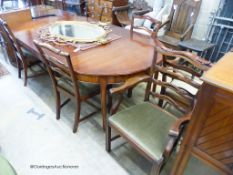 A reproduction George III Style mahogany D-end extending dining table, 236cm extended, 2 spare