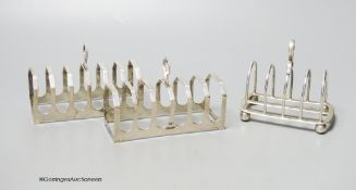 A pair of silver toast racks, Sheffield, 1950, 11.3cm and one other silver toastrack, 7oz.