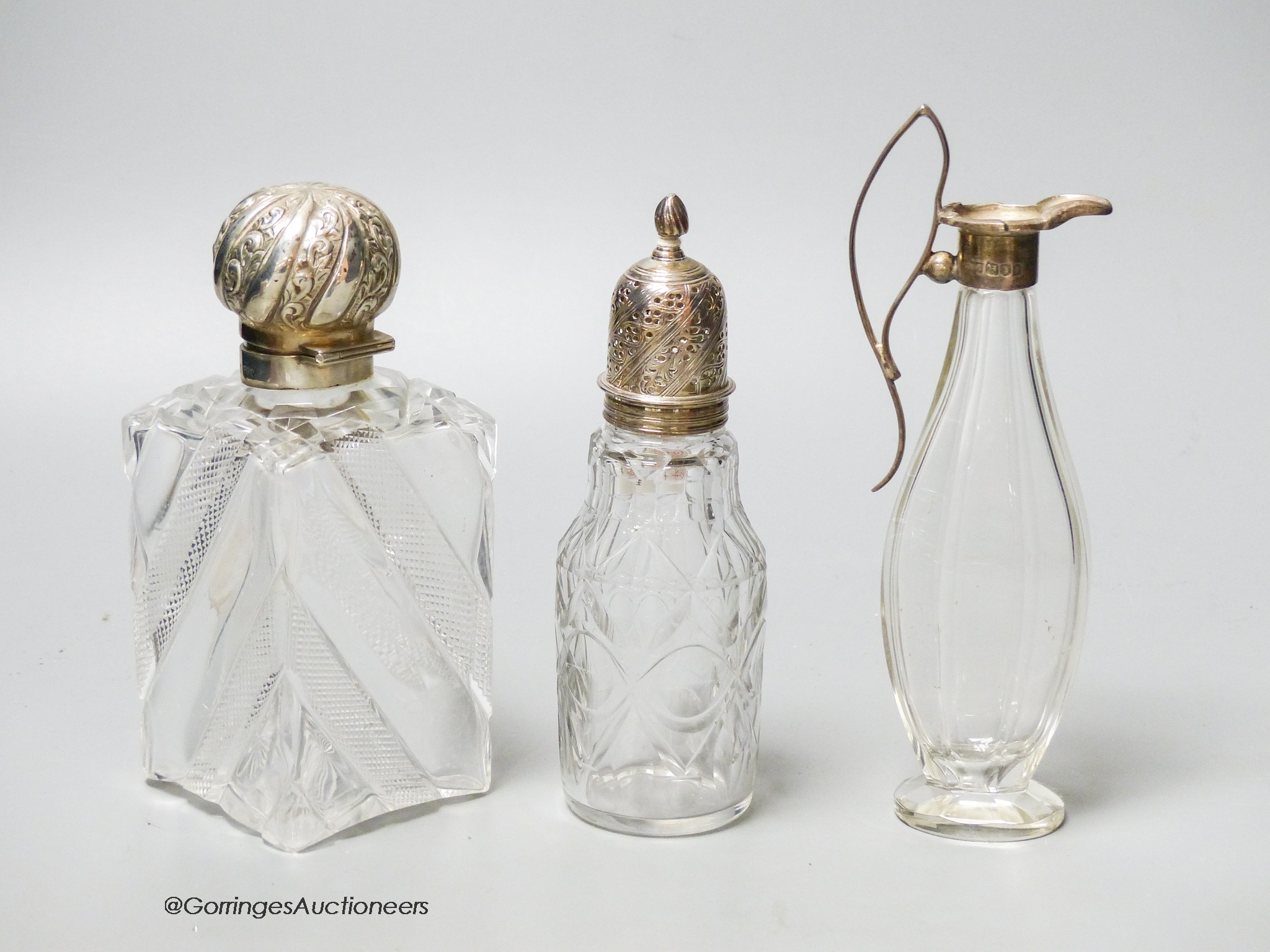 A late Victorian silver topped cut glass scent bottle, London, 1890, 15cm, a later silver mounted