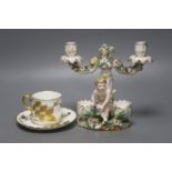 A John Bevington figural candelabra, height 19cm, and a cup and trembleuse saucer