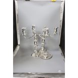 A pair of silver plated candelabra, two plated salvers and two plated mustard pots