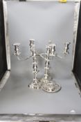 A pair of silver plated candelabra, two plated salvers and two plated mustard pots