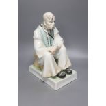 A Zsolnay porcelain figure of a seated peasant, height 33cm