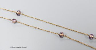 A yellow metal (stamped 14k) and facet cut purple stone set guard chain, 98cm, (link has become