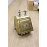 A Dutch embossed brass coal scuttle