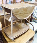 An Ercol elm drop flap three tier tea trolley, length 73cm, depth 46cm, height 76cm