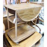 An Ercol elm drop flap three tier tea trolley, length 73cm, depth 46cm, height 76cm