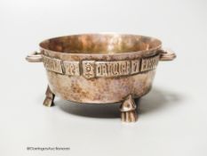 A George V Arts & Crafts planished silver twin-handled bowl, with applied Latin scripted border, F.