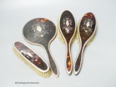 A 1920's silver and tortoiseshell pique four piece mirror and brush set.