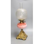 A Victorian cranberry glass and gilt metal oil lamp, with two shades, height 59cm