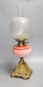 A Victorian cranberry glass and gilt metal oil lamp, with two shades, height 59cm