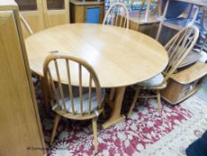 An Ercol elm circular drop leaf dining table, 126cm diameter, height 71cm together with four Ercol