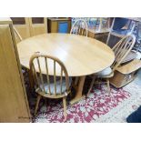 An Ercol elm circular drop leaf dining table, 126cm diameter, height 71cm together with four Ercol