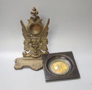 A Victorian cast watch stand and a gilt metal framed plaque