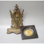 A Victorian cast watch stand and a gilt metal framed plaque