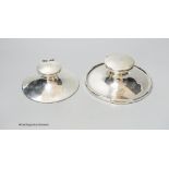 Two George V silver mounted capstan inkwells, marks rubbed, largest diameter 15.3cm.