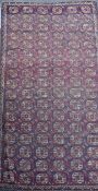 A Bokhara burgundy carpet, 356 x 184cm