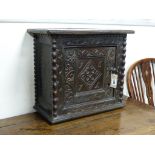 A Charles II carved oak wall cupboard (possibly Dorset),of rectangular form, the single panelled