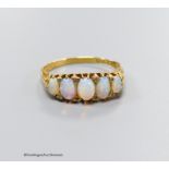 An Edwardian 18ct gold and graduated white opal set half hoop ring, with diamond chip spacers, size