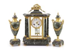 A 19th century French ormolu mounted black variegated three piece clock garniturethe white