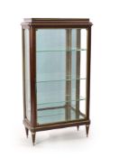 An early 20th century French ormolu mounted mahogany vitrinewith moulded top and single glazed door