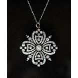 A good Victorian gold, silver and diamond set open work pendant,of quatrefoil shape, the central